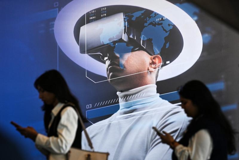 Visitors and a virtual reality headset displayed at the AI Impact Summit.